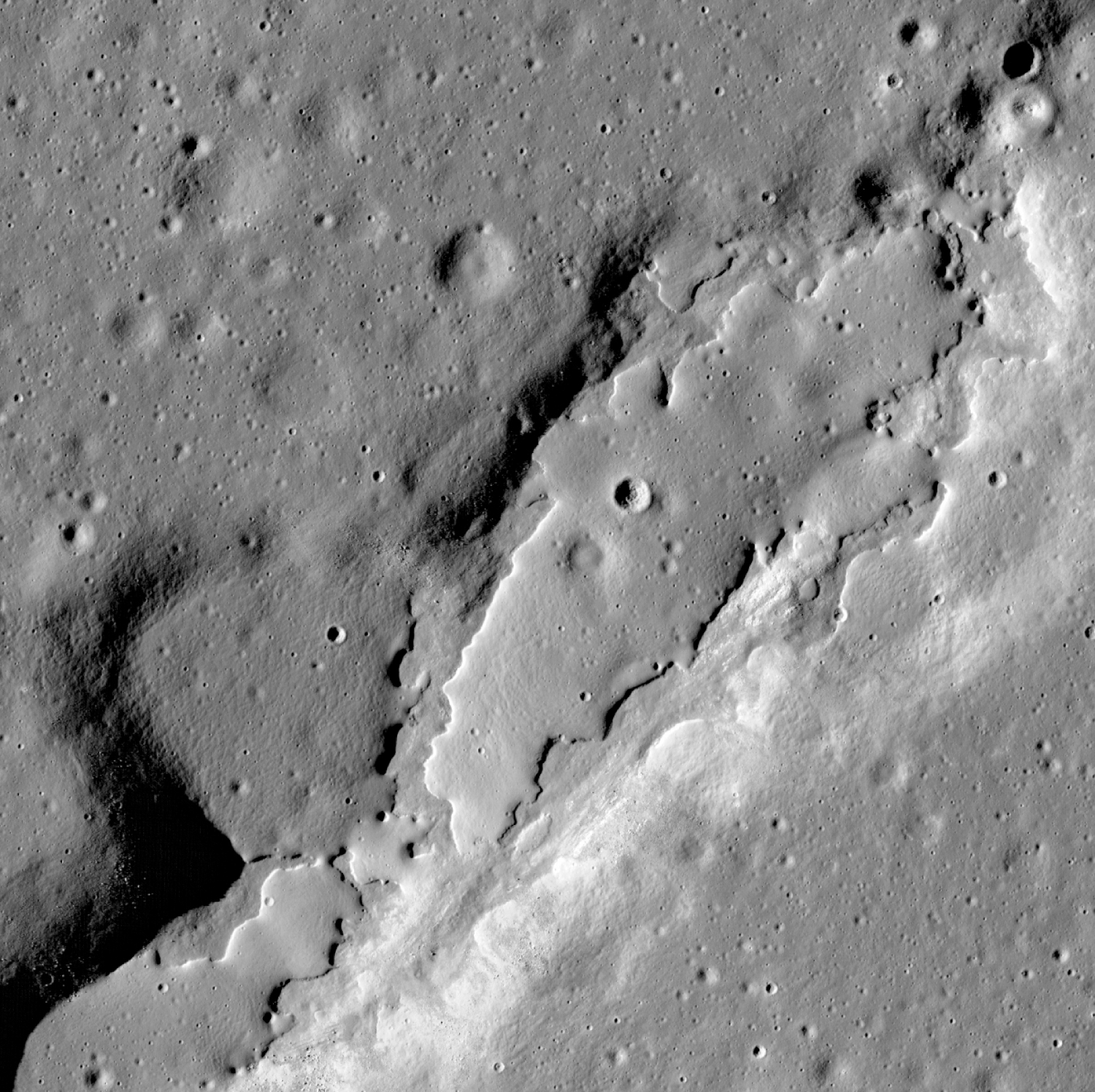 Lava flows have spread across the floor of this large collapsed area. Their lack of impact craters and steep sides show that they erupted relatively recently.  The LROC team reported in Nature in 2014 that some of these volcanic features could be younger than 100 million years old.  Their adolescence suggests that the moon’s interior is perhaps hotter than once thought, and that future eruptions could occur on its surface. Credit: NASA/Goddard Space Flight Center/Arizona State University 