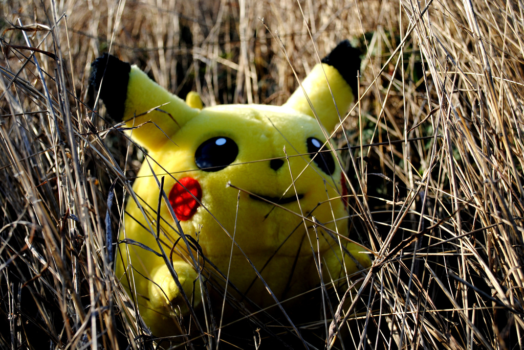 Pikachu, from the game Pokemon, crouches in the grass. Credit: Sadie Hernandez/Flickr [CC-BY