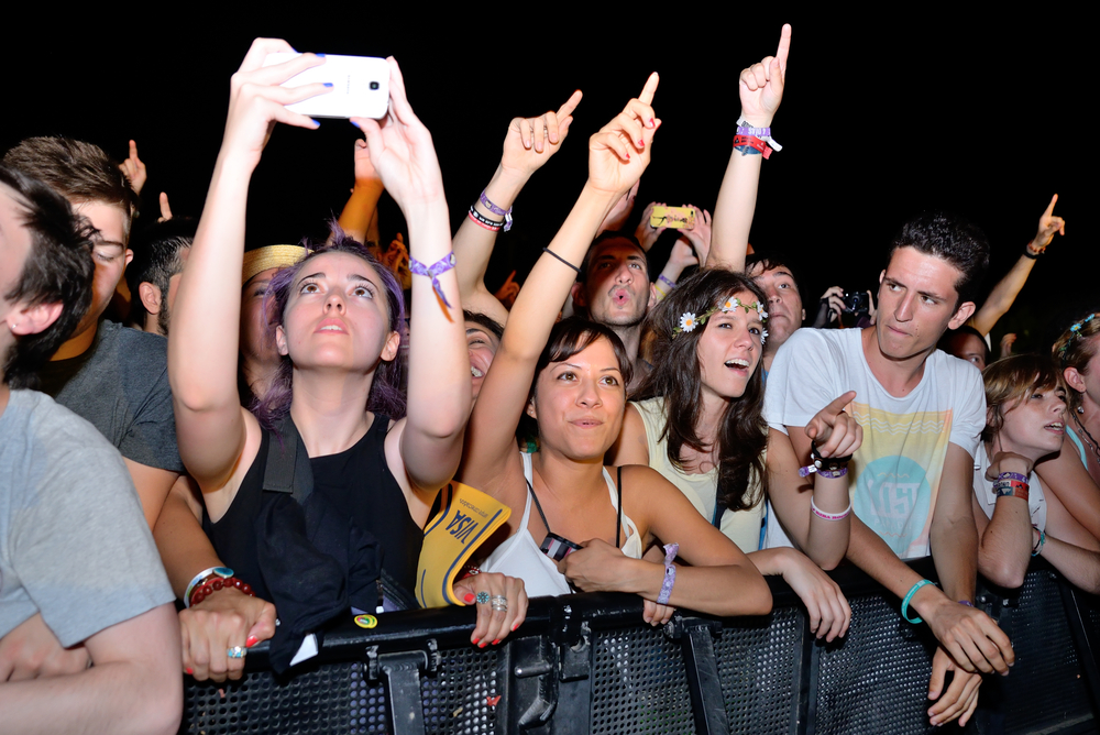 A woman taking a video with her phone, from Shutterstock