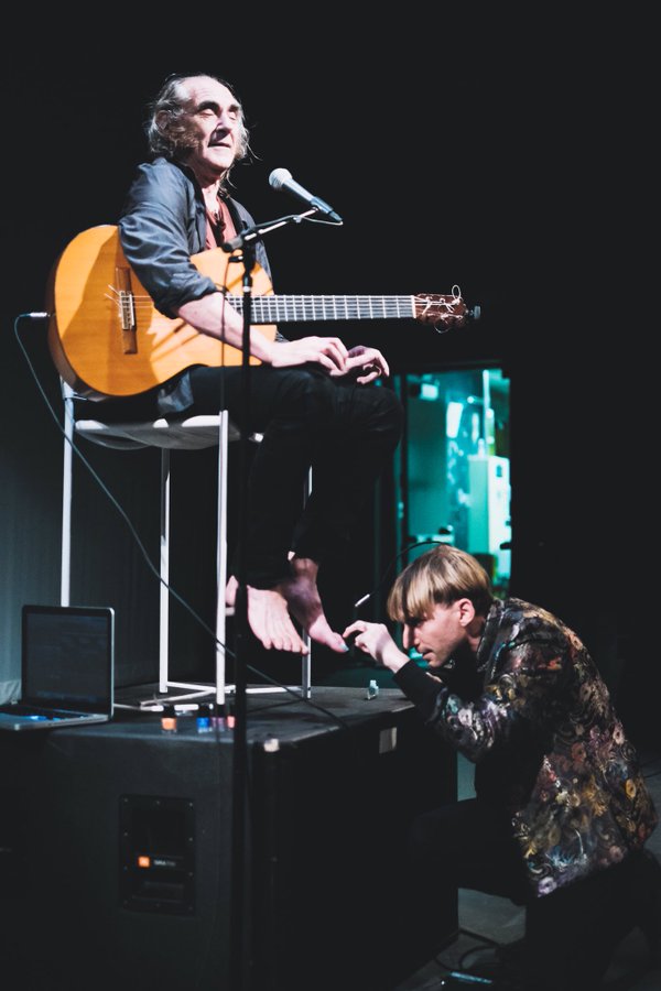 Harbisson gives guitarist Pau Riba a cyborg pedicure at Moogfest. Image by Carlos Gonzalez
