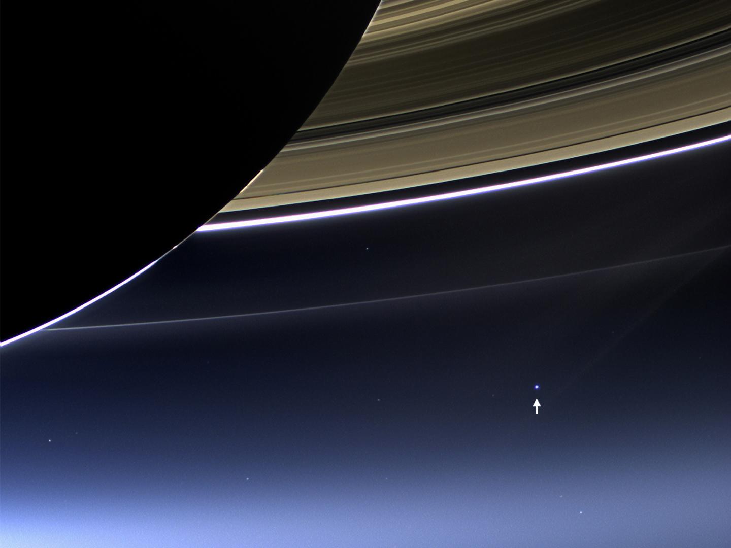 This rare image has captured Saturn's rings and our planet Earth and its moon in the same frame. Earth, which is 898 million miles away in this image, appears as a blue dot at center right; the moon can be seen as a fainter protrusion off its right side. Credit: NASA/JPL-Caltech/Space Science Institute