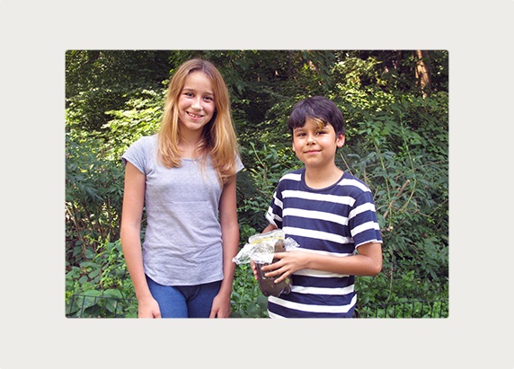 Smiling learners hold up their completed column.