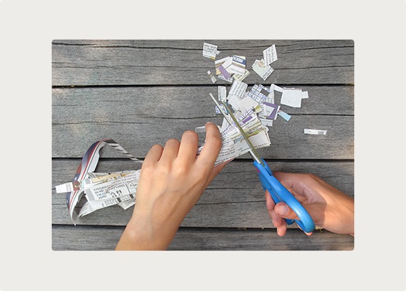 A person cuts up newspaper.