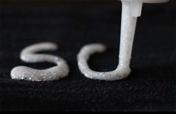 A puffy pain on black paper spells out "sc."