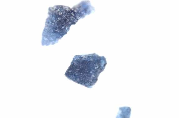 under a microscope, ragged blue crystals