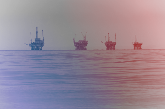 four oil rigs in a row in the ocean