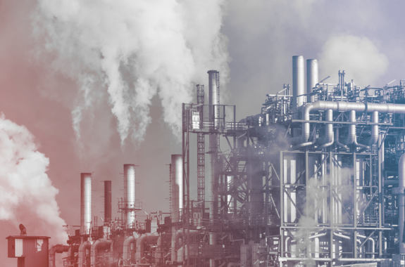 oil refinery with smoke coming out of stacks