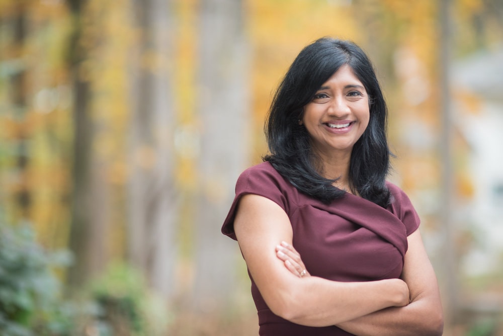 aruna miller standing with arms crossed