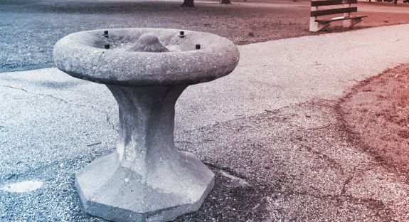 stone water fountain with red and blue filter overlaid
