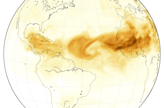 abstract version of the globe with the Americas, parts of Europe and Africa, with dark sand flowing westward