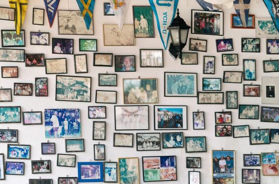 Many family photos against a white wall