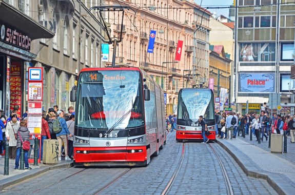 two trolleys going down a street, with a man dashing out in front of one in a way reminiscent of the trolley problem