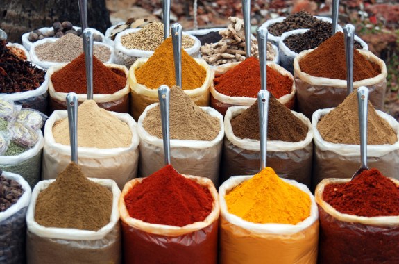 colorful spices in bags sitting in a row on display
