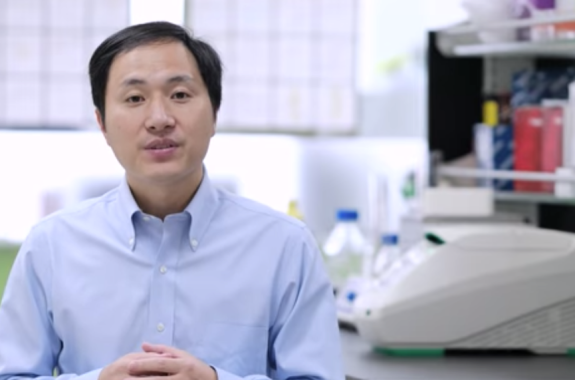 chinese scientist standing in front of lab equipment