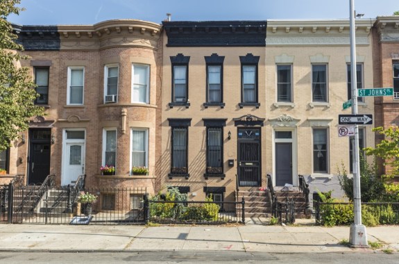beige row houses on a sunny city street