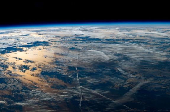 the sun rises over planet earth