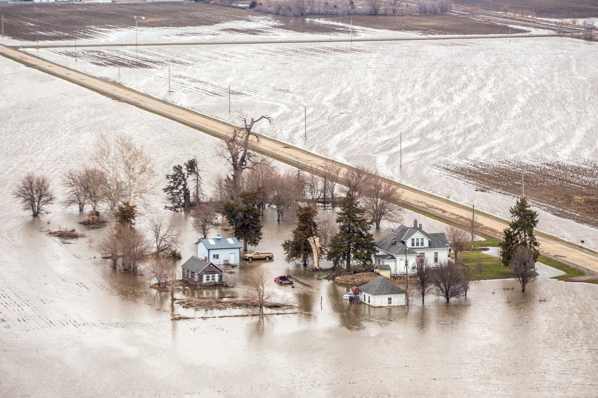 a large farm field flooded in brown water