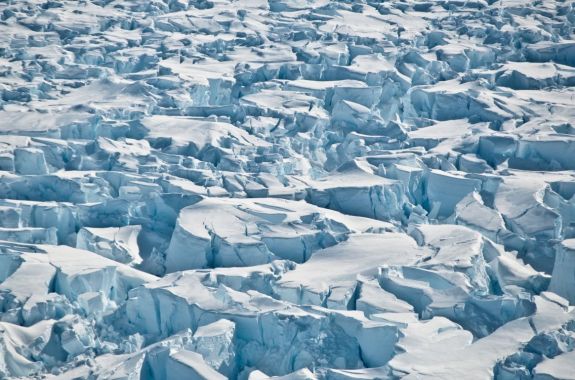 blue white ice that is completely etched with deep cracks
