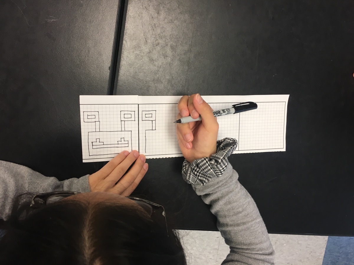 overhead shot of a student drawing their alien