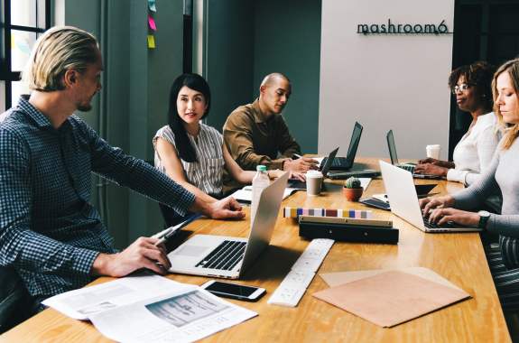 Group of people working around a desk