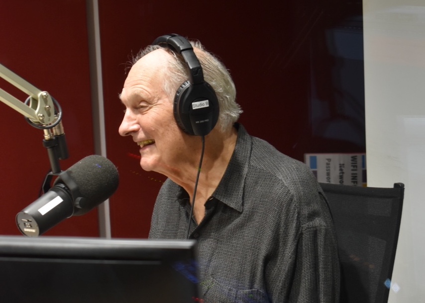 alan alda in a studio laughing