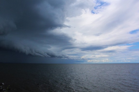 a storm brews over an expansive lake