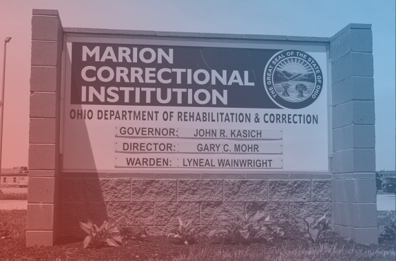 a sign that reads marion correctional institution, ohio department of rehabilitation and corrections. the image has a blue and red filter