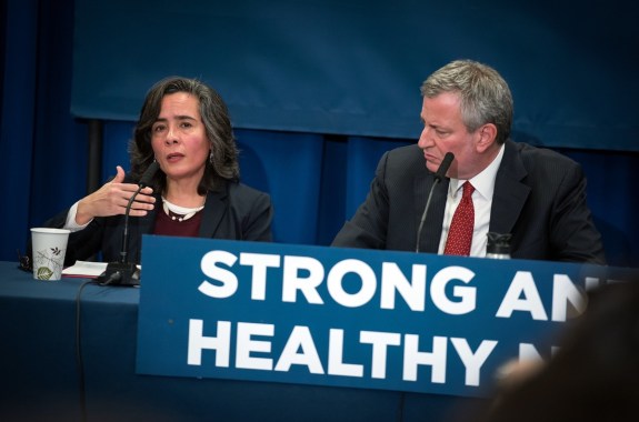 a woman and a man on a panel speaking
