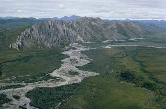 a landscape shot of mountains and a large long river
