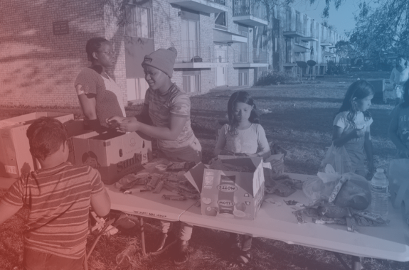 a family at a table full of emergency supplies. it has a red and blue filter over it