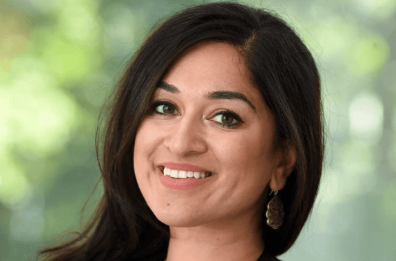 a woman smiling looking at the camera