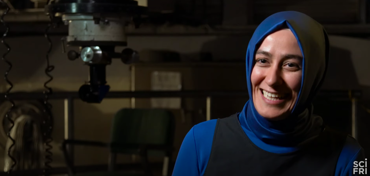 a woman wearing a hijab smiling