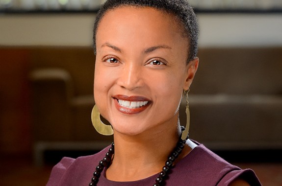 a Black woman smiling at the camera