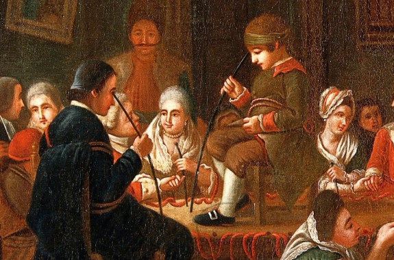 a colored oil painting of people in 18th century attire. one of the men sitting has a rod held up to his forehead. a child sitting on a chair atop a table is holding a rod up to his head too