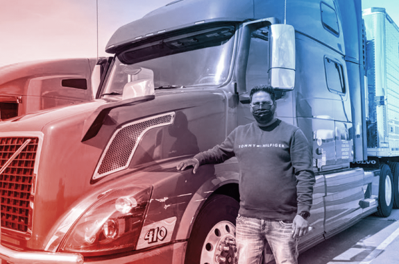 a man in jeans, a long sleeve shirt, and face masks stands in front of a large orange transportation truck. the image is filtered blue and red