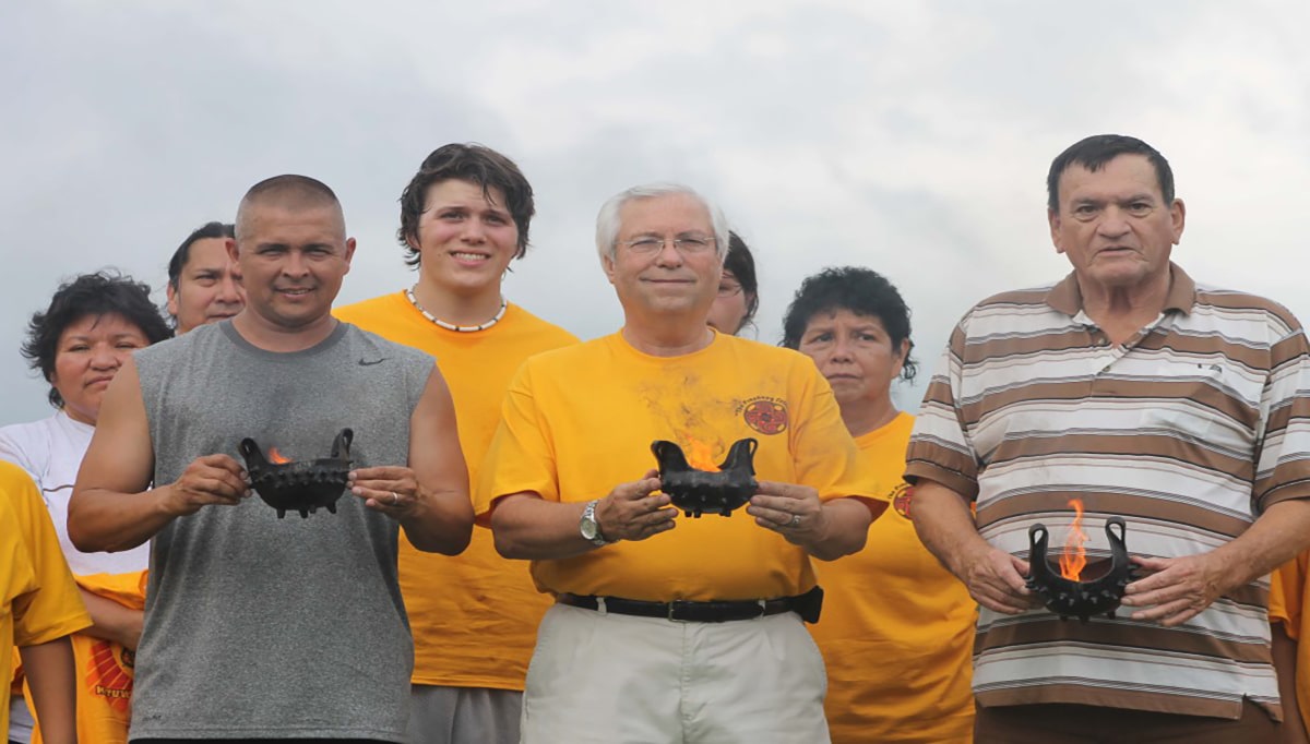 Eastern Band of Cherokee Principal Chief Michell Hicks, Cherokee Nation Principal Chief Bill John Baker and United Keetoowah Band Principal Chief George Wickliffe hold fire pots during the historic Tri Council Meeting at Kituwah Mound on Thursday, July 12, 2012