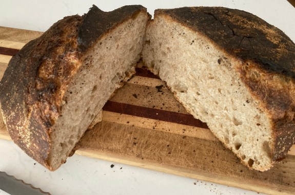 a loaf of sourdough bread sliced in the middle to see its rich density