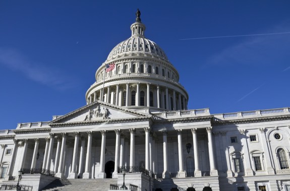 looking up at the u.s. capitol building on a cloudless day