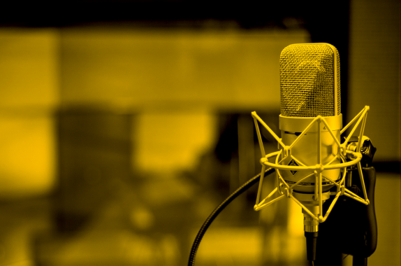 a professional microphone in a recording studio. the image is filtered gold