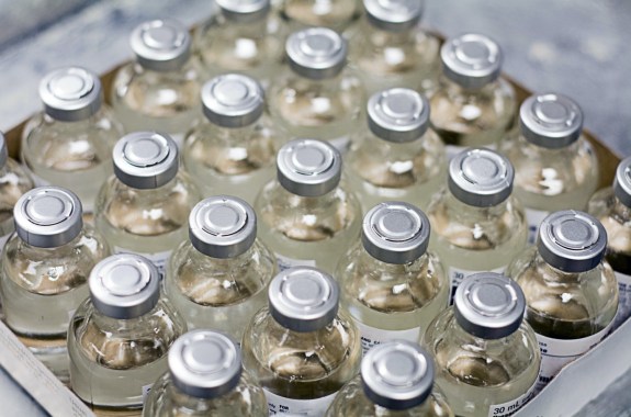 a box of over a dozen vaccine vials