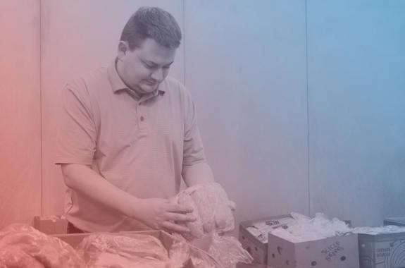 a man inspecting bread at a food pantry