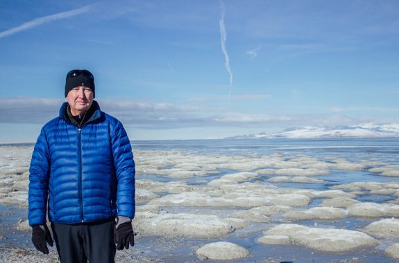 Kevin Perry at the great salt lake in front of dried microbialite communities, Utah