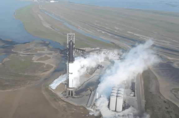 A smoking rocket still in the launch setup.