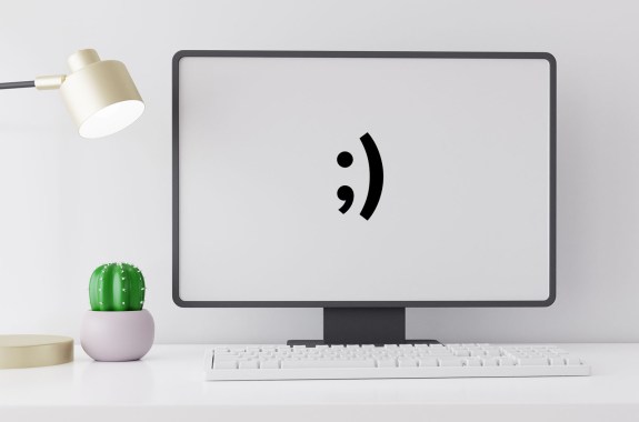 A computer screen with a winky face on it
