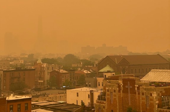 A bright orange haze covers New York City