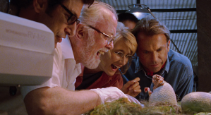 Ellie (Laura Dern) and Grant (Sam Neill) watch a baby raptor hatch in "Jurassic Park."