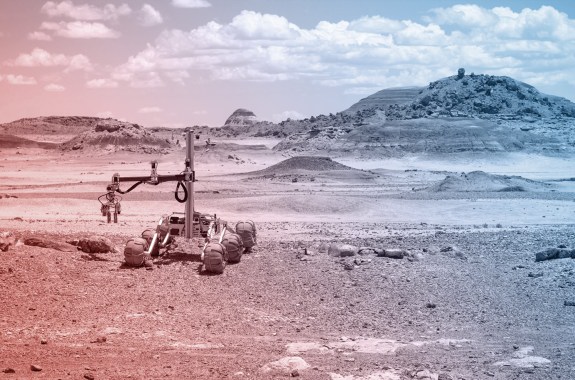 A four wheeled rover drives across a Mars-like desert, that's actually just the desert in Utah.