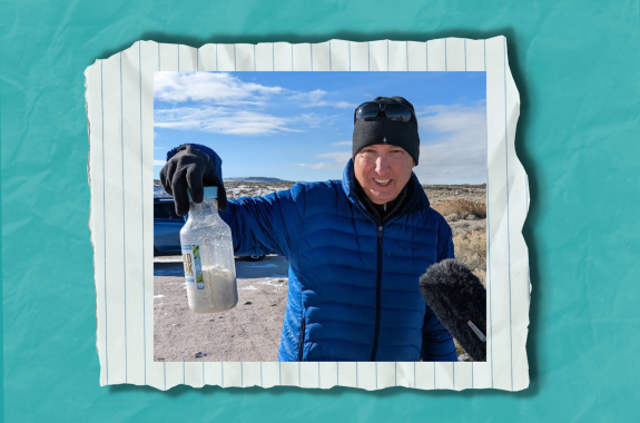 A man holding up a bottle of salt at the Great Salt Lake