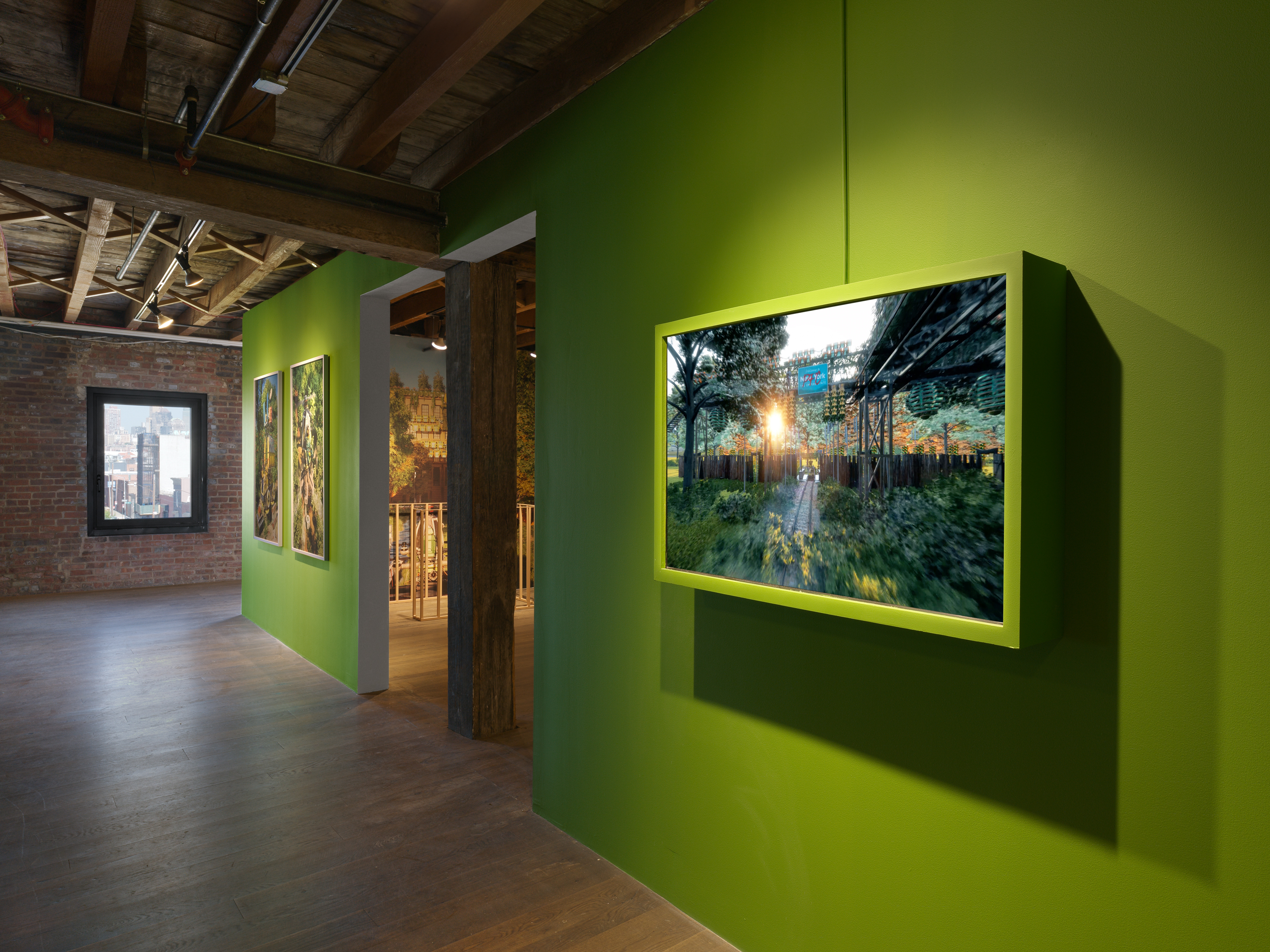 A green wall adorned with paintings of nature.