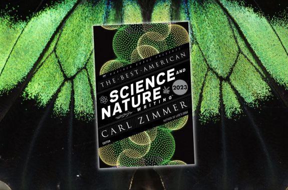 In the middle of the frame is the book cover of THE BEST AMERICAN SCIENCE AND NATURE WRITING 2023. The background is a close-up photo of a green-and-black butterfly wing.